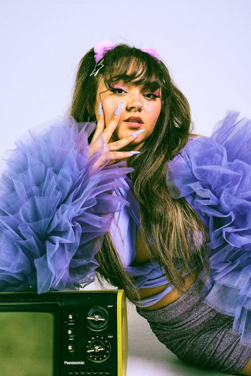 A Woman Wearing a Purple Top with Ruffles