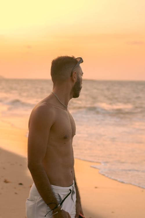 Free Topless Man at the Beach Stock Photo