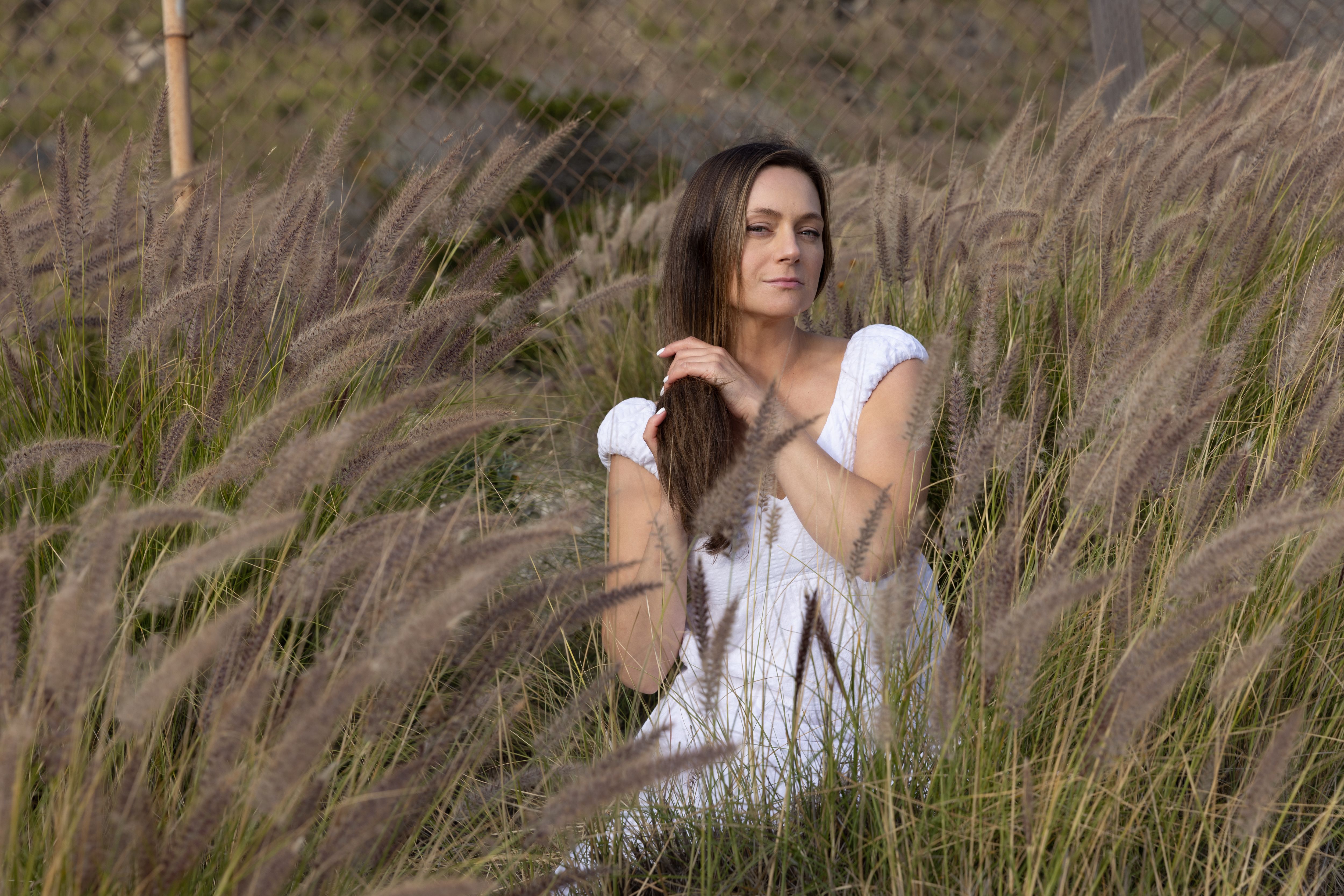 Woman in a White Dress Standing in a Meadow · Free Stock Photo