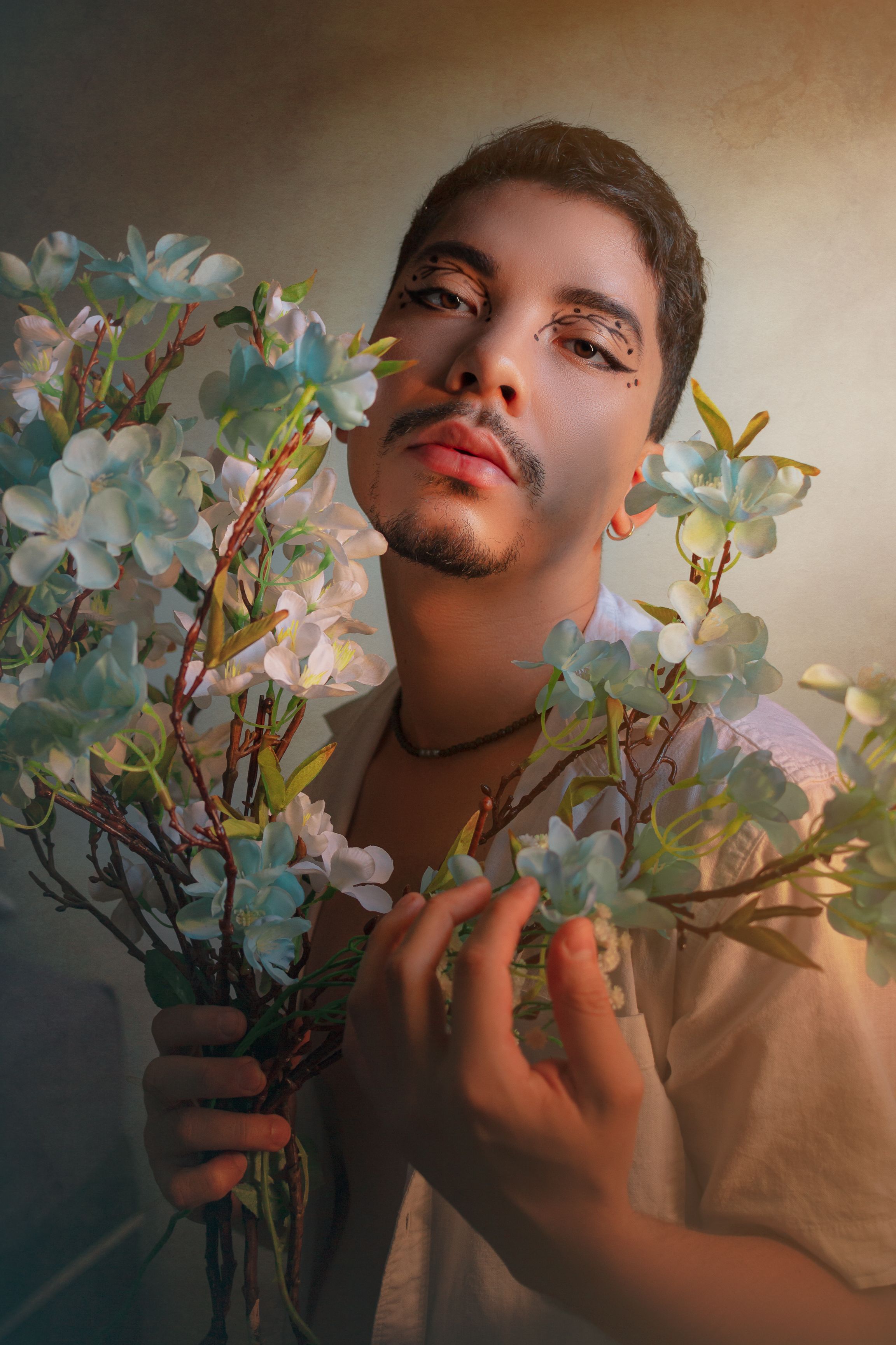 Captivating portrait of a person surrounded by decorative flowers, exhibiting an artistic mood.