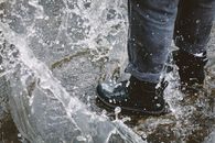Photo of a Person Splashing Water on the Ground
