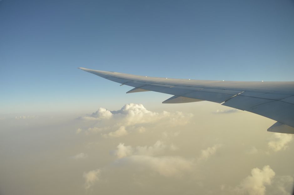Commercial airplane soaring over the desert landscape of Kuwait