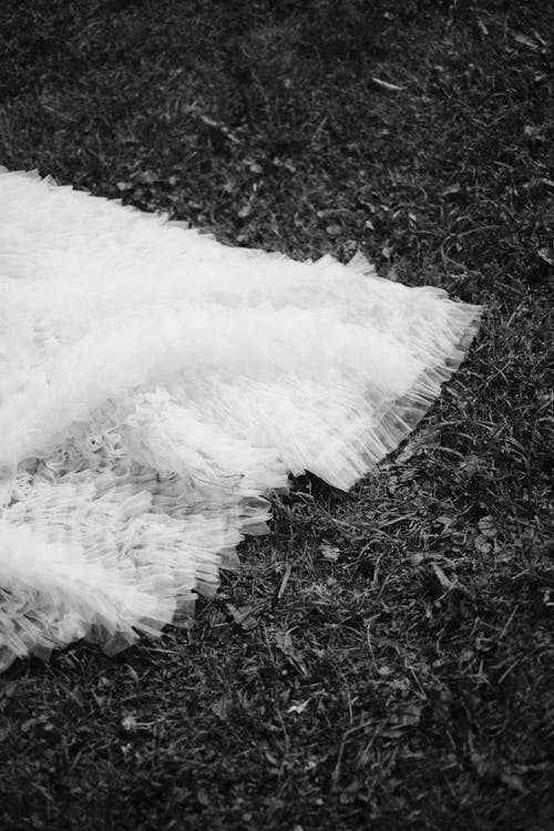 White Textile on Grass