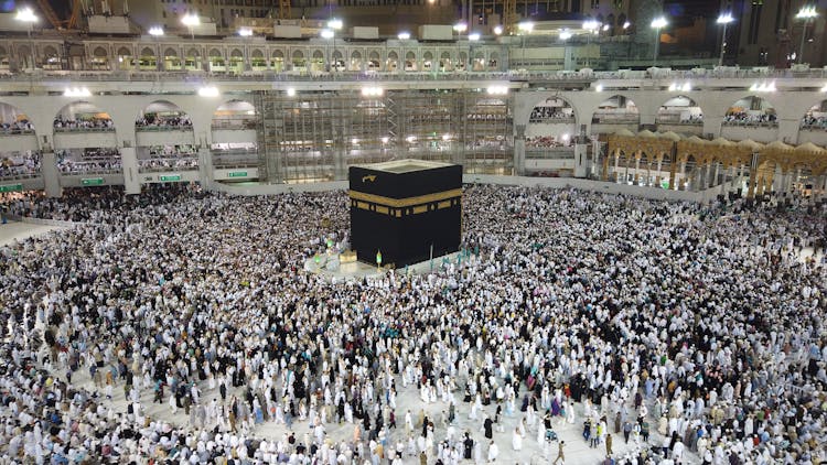 A Group Of People Standing Near The Kaaba