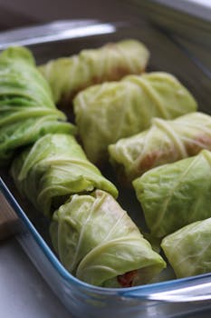 Appetizing homemade stuffed cabbage rolls arranged in a glass baking dish.