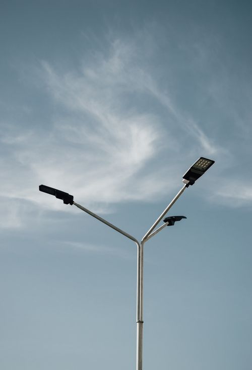 Free A modern street lamp stands tall against a clear blue sky, capturing minimalist beauty. Stock Photo