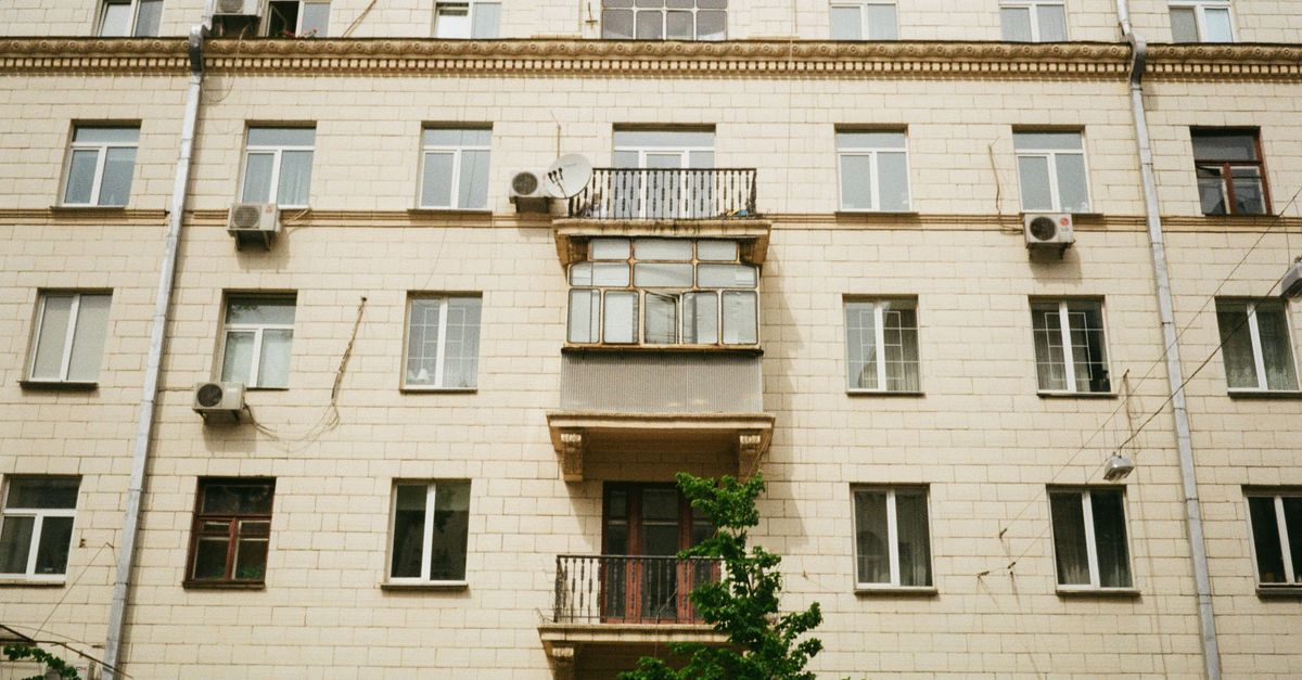Front view of a modern apartment building in Kyiv featuring windows and balconies.