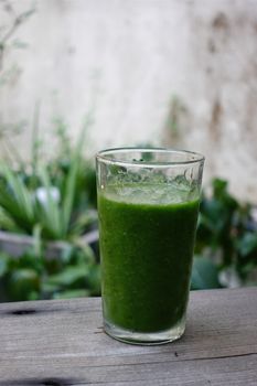 Vibrant green vegetable smoothie in a clear glass, ideal for a healthy, refreshing drink.