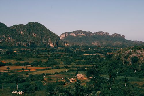 Free A stunning aerial view of the lush green countryside and mountains in Cuba, under a clear sky. Stock Photo