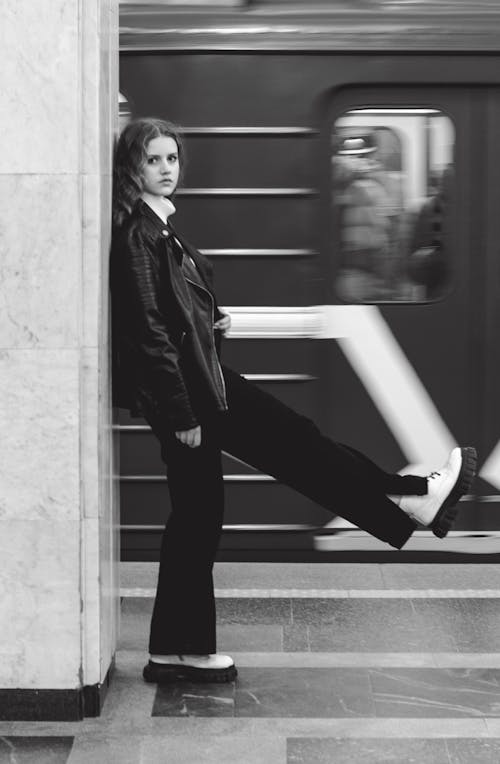 Grayscale Photo of a Woman with Her Leg Raised