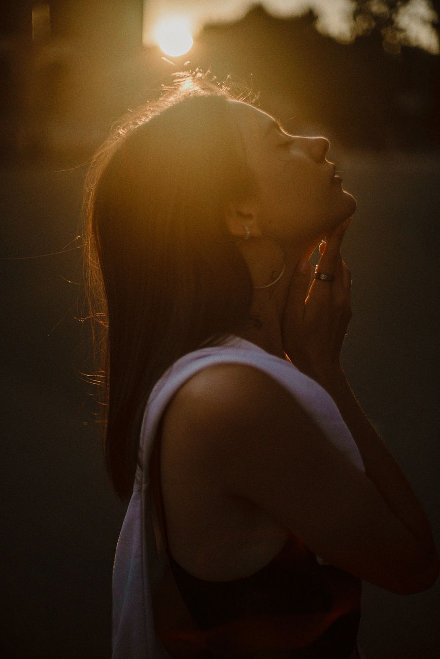 A peaceful woman enjoys the warm glow of the sunset in Kyiv.