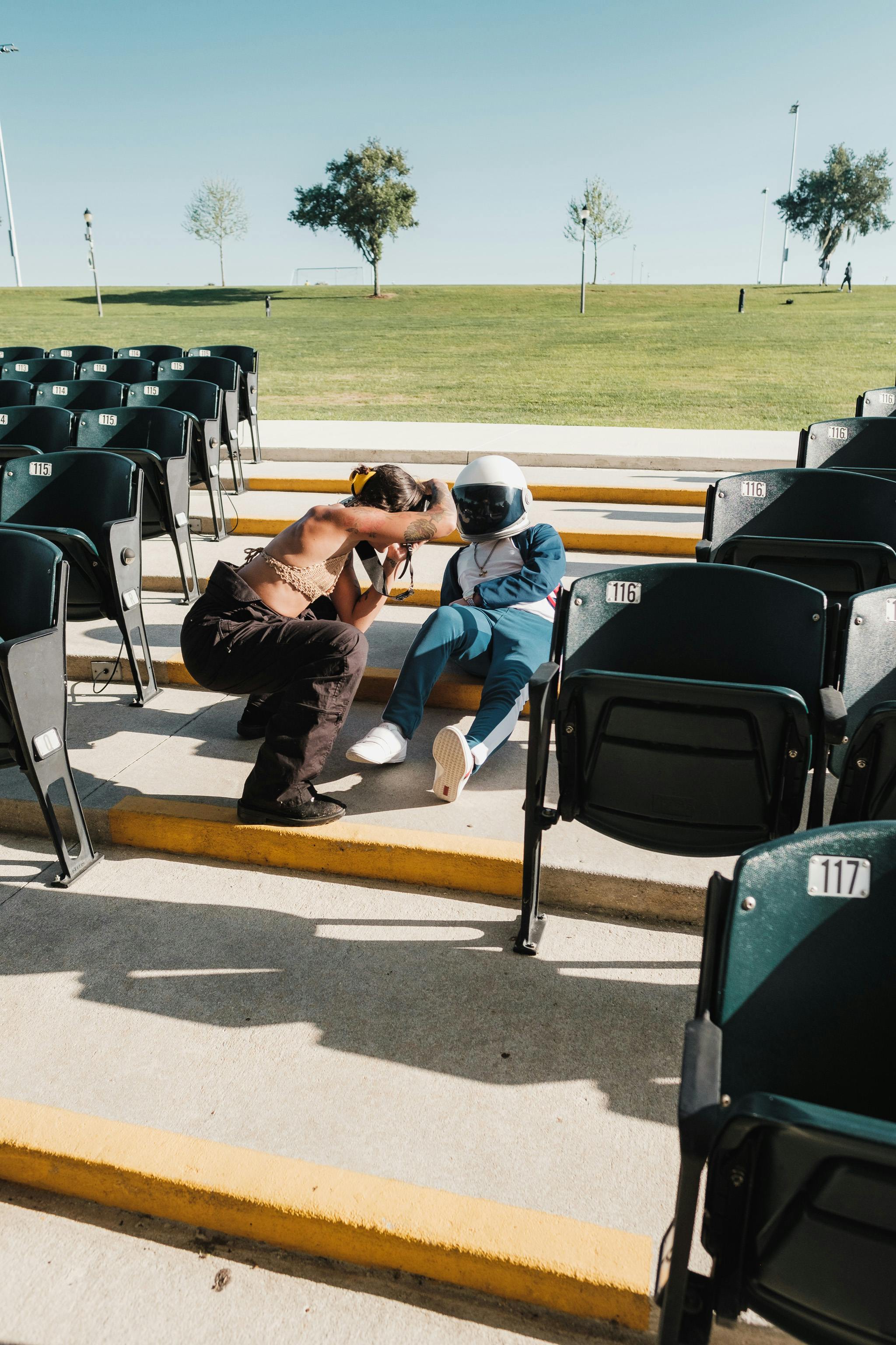 two people sitting on a stadium seat