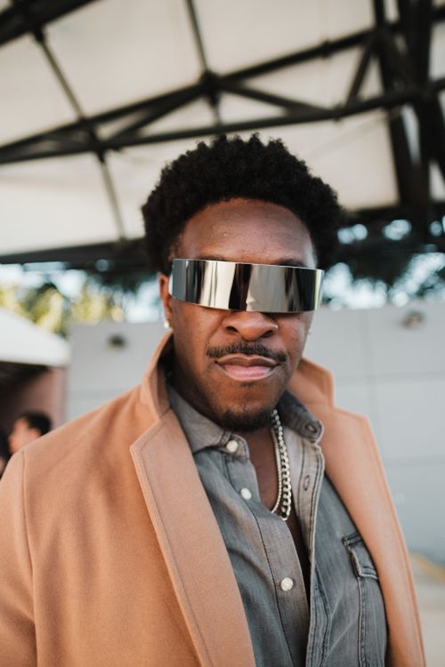Free A fashionable African American man in futuristic sunglasses poses confidently outdoors in Orlando, FL. Stock Photo