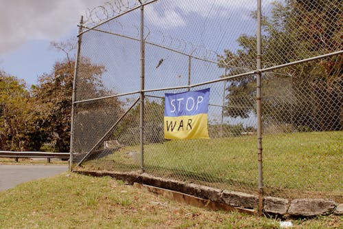 A Banner on a Metal Fence