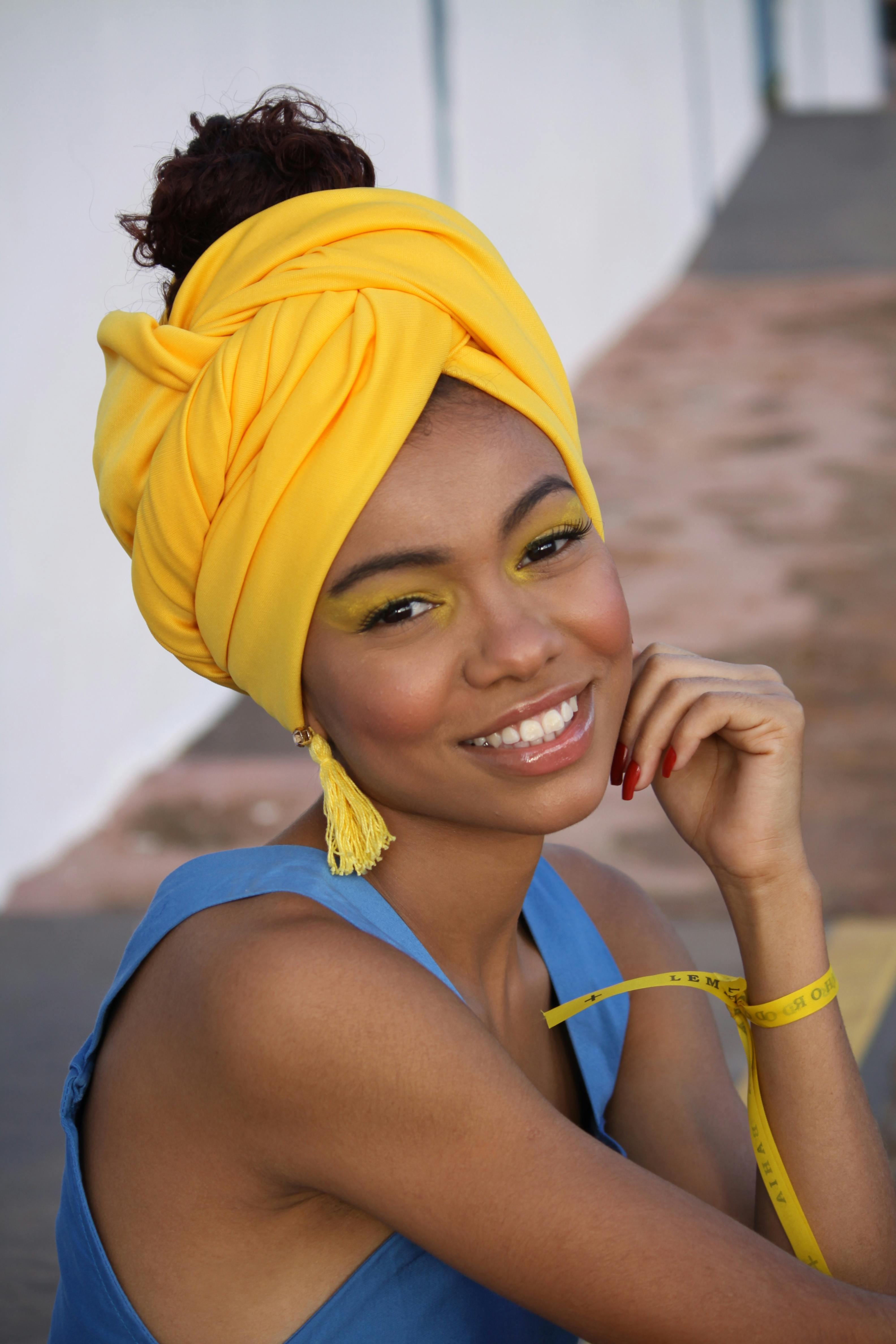 a woman with a yellow headwrap