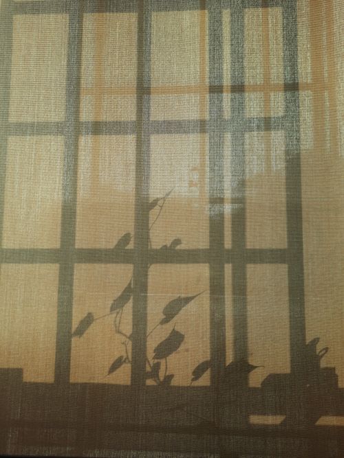 Free Subtle shadows of leaves on a curtain create a textured, minimalistic pattern. Stock Photo