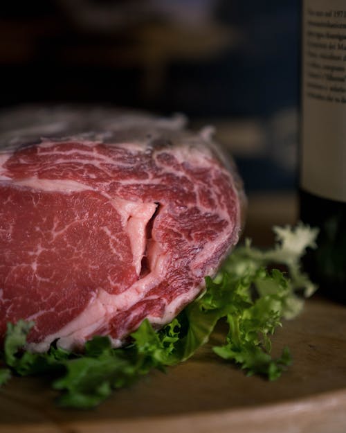 Close-up of Raw Beef Lying on Lettuce 