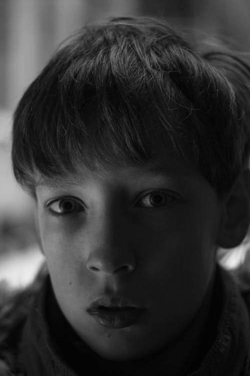 Grayscale Photography of a Boy Looking at the Camera