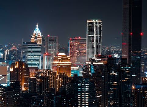 Illuminated Taipei skyline featuring skyscrapers and vibrant city lights at night.