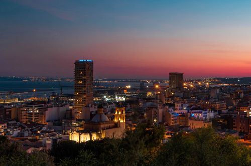 Free Discover Alicante's stunning skyline during a vibrant sunset over the city. Stock Photo
