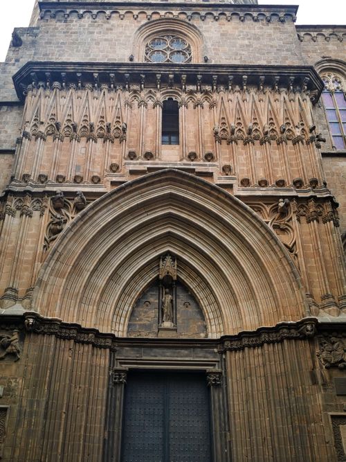 Free Gothic facade of the Barcelona Cathedral's entrance, showcasing intricate stonework and historical design. Stock Photo