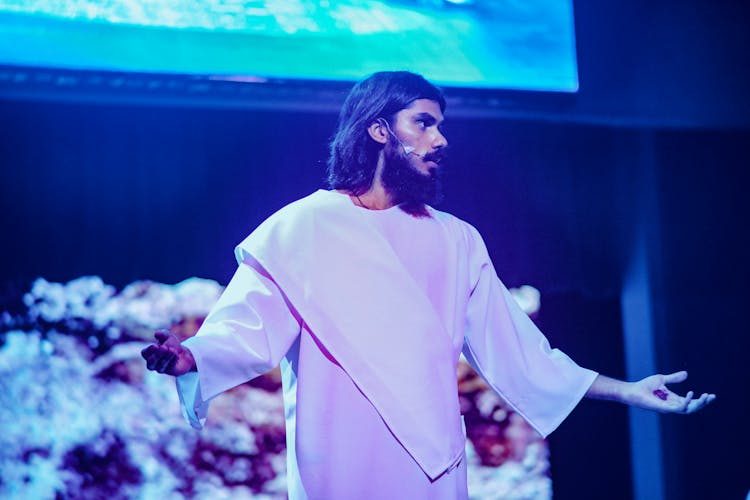 An Actor Portraying Jesus Standing On Stage