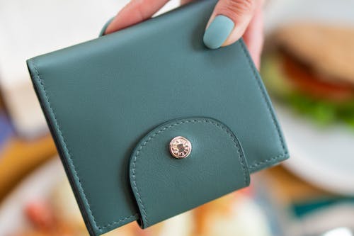 Close-Up Photograph of a Person Holding a Leather Wallet