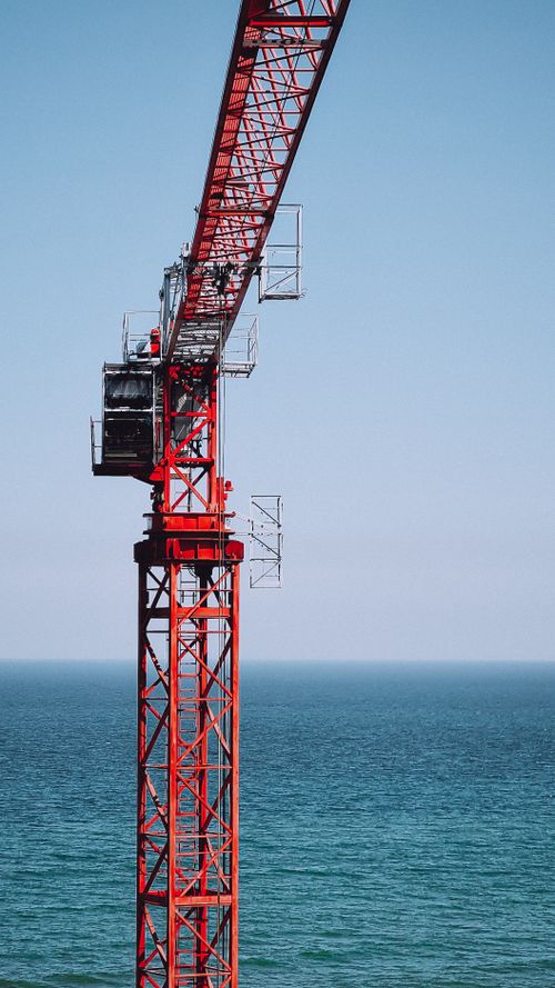 Free A towering red crane near the ocean in Pionersky, Kaliningrad Oblast. Stock Photo