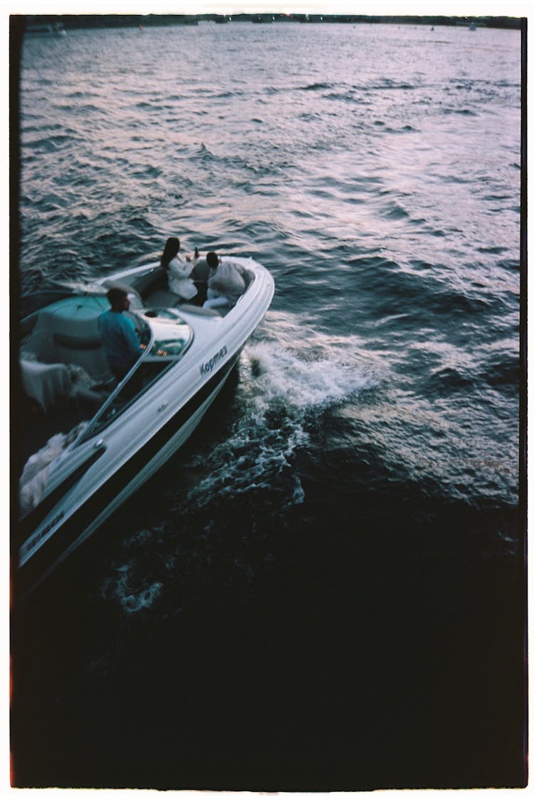 People Riding A Speedboat In The Sea