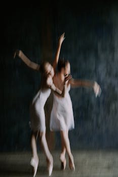 Artistic depiction of two ballerinas captured in motion blur during a graceful dance.