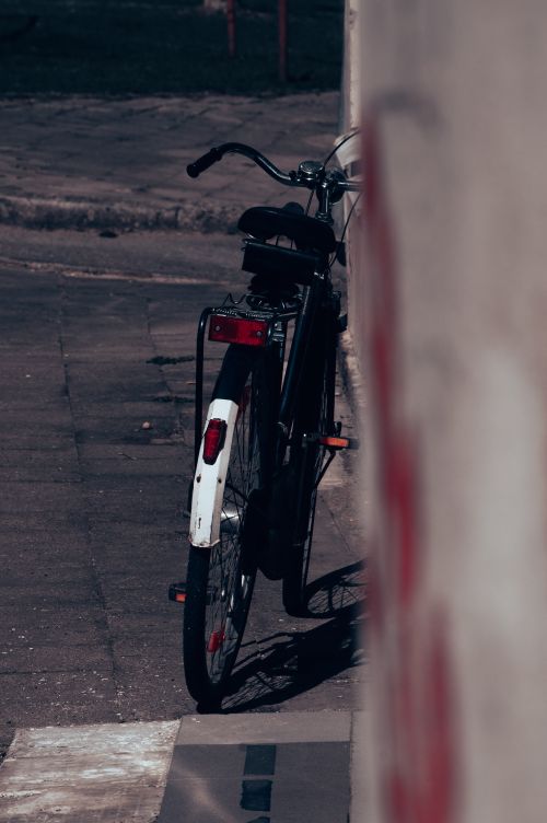 Free A vintage bicycle rests against a city wall in Lithuania, evoking a nostalgic urban scene. Stock Photo