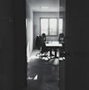 Black and White Photo of a Man Working In a Office