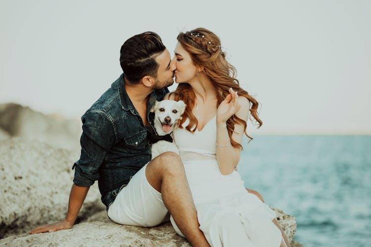 Couple With Their Dog Kissing 