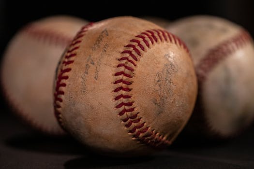 A close-up photo of weathered baseballs emphasizing texture and selective focus.