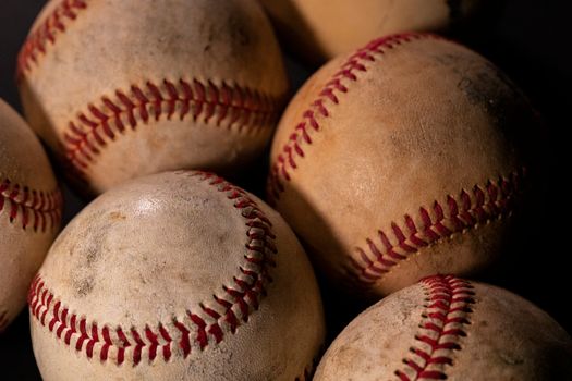 Close-up view of weathered baseballs highlighting texture and details.