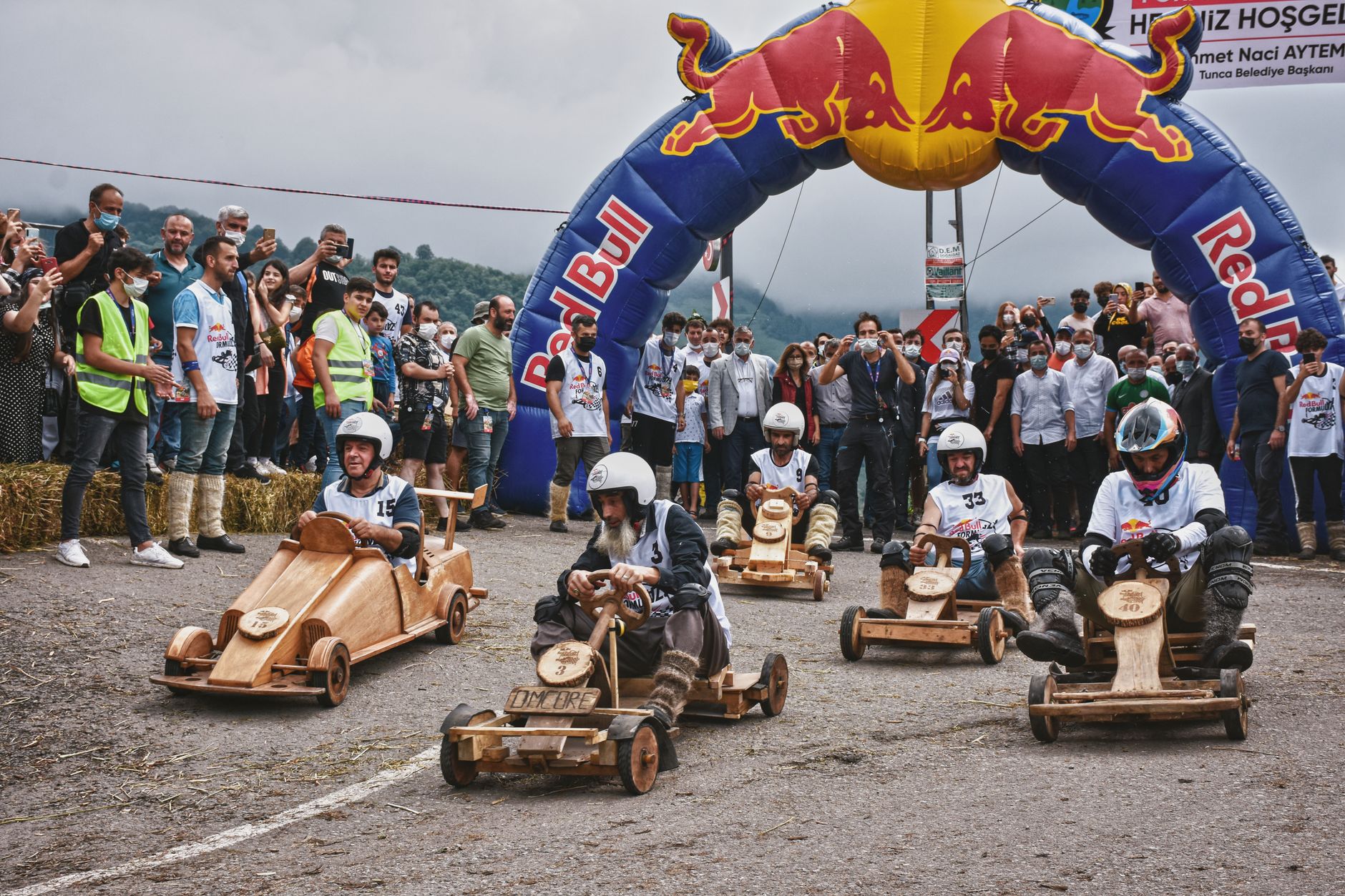Exciting go-kart race event with wooden karts and a cheering crowd in Tunca, Türkiye.