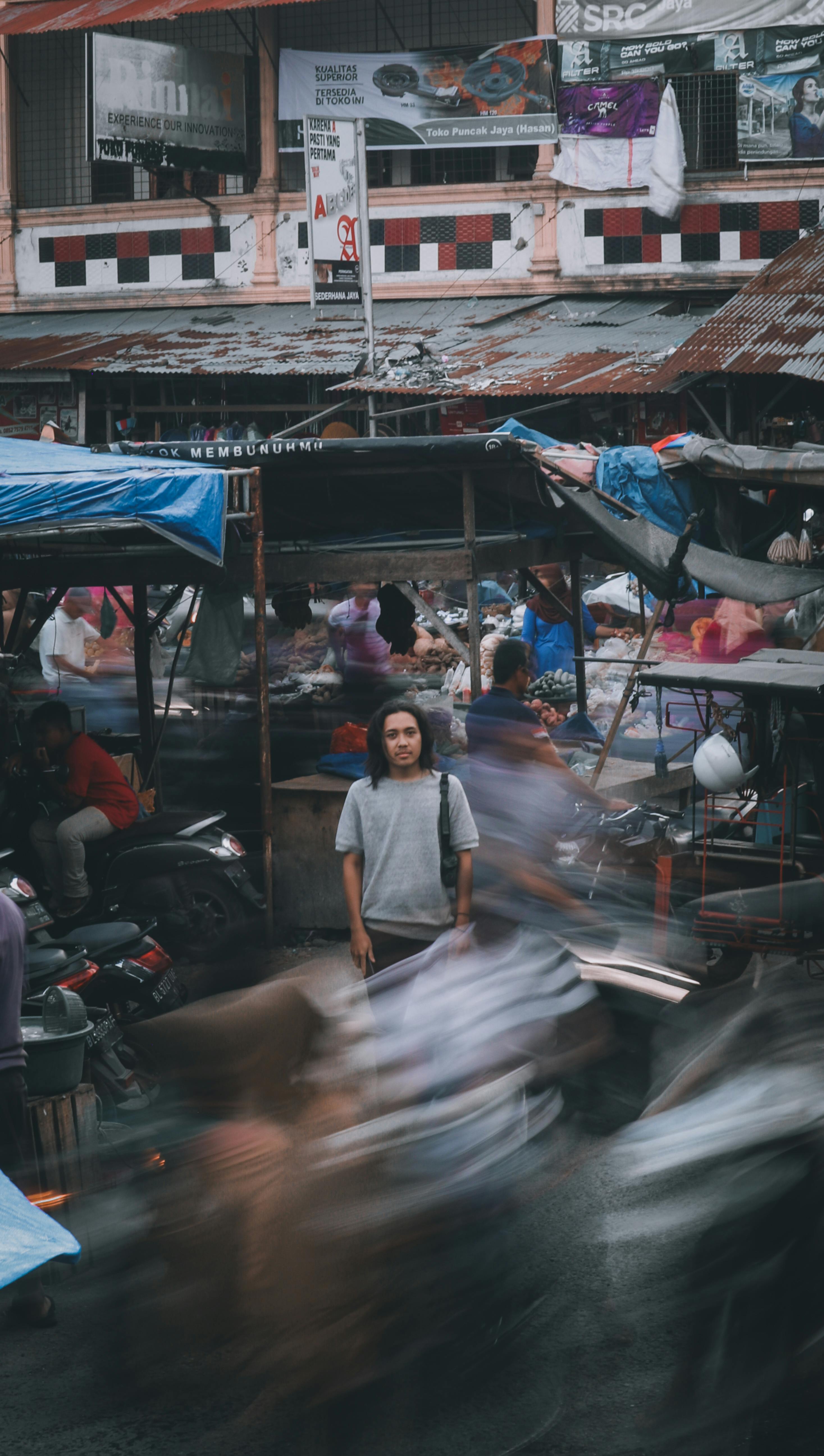 A bustling street scene in Langsa, Indonesia showcasing motion and daily life.