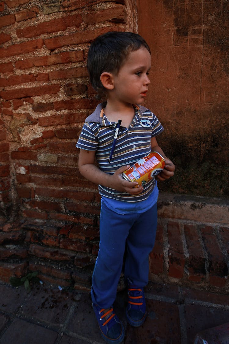 Photo Of Boy Holding A Can