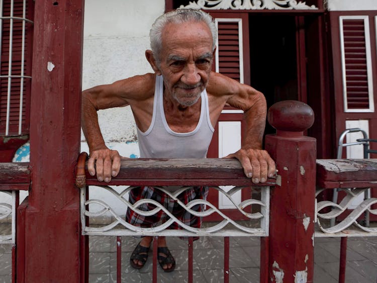 Photograph Of An Elderly Man In A White Tank Top Exercising