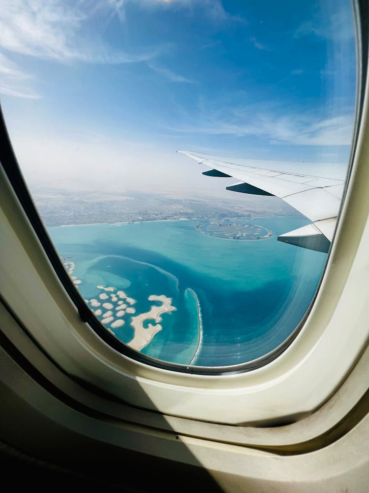 View Of The Palm Island In Dubai From An Airplane Window