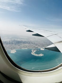 Captivating view of Dubai skyline and coastline from an airplane window.