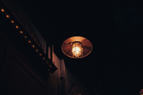 Free A glowing vintage lamp casts warm light at night in Izmir, Turkey. Stock Photo