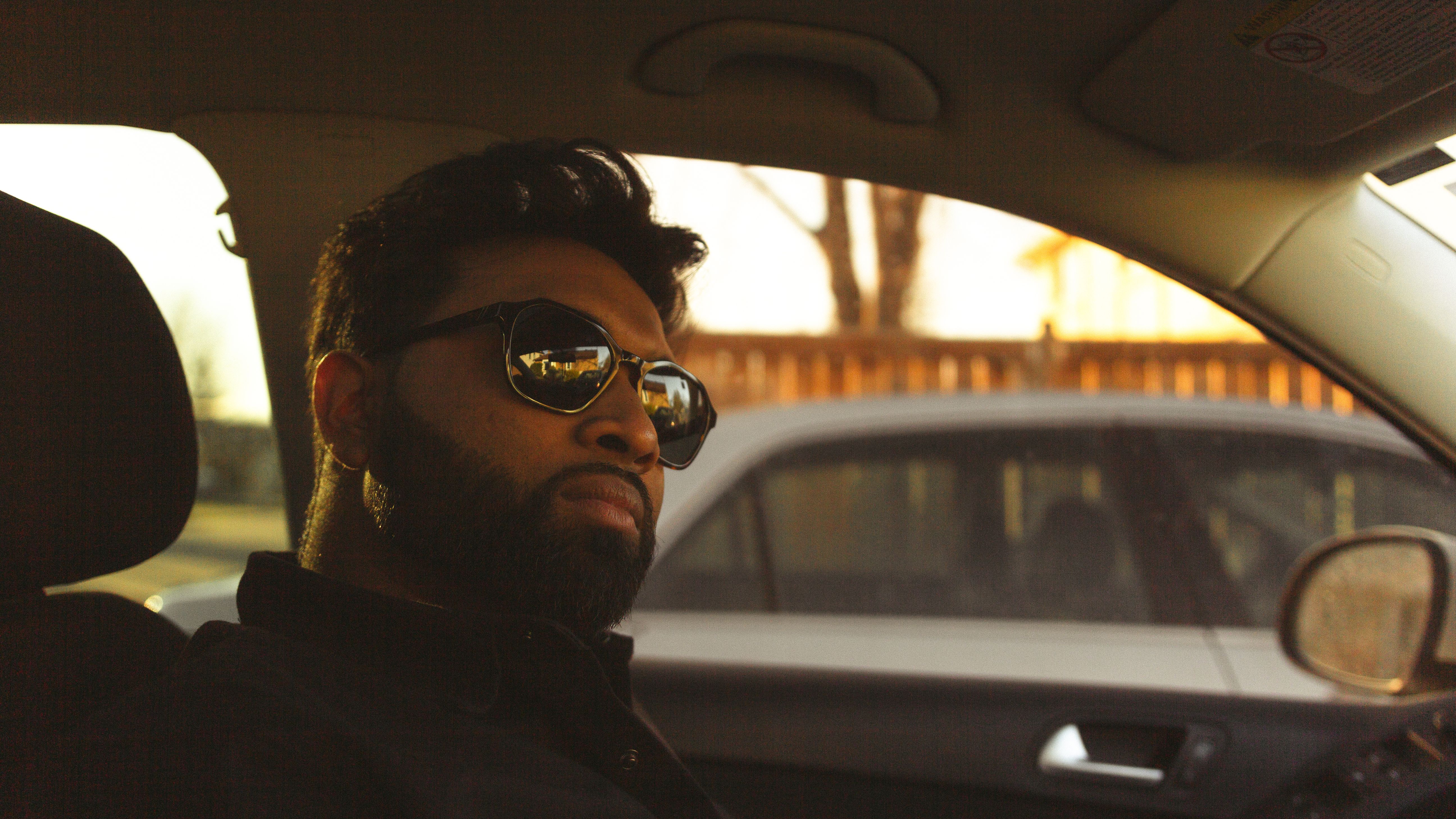 A Man Wearing Sunglasses Sitting inside a Car · Free Stock Photo