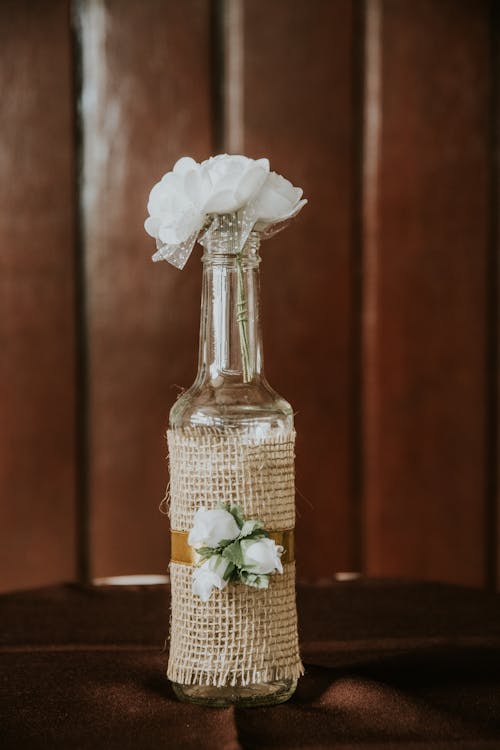 White Flower in Clear Glass Bottle