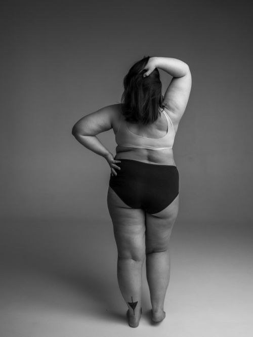 Free Black and white portrait of a confident plus size woman in underwear from the back. Stock Photo