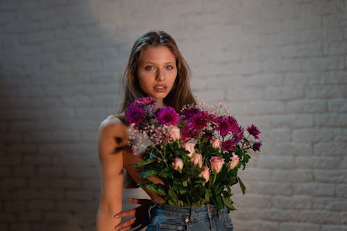 Free A Woman with Flowers on Her Pants Stock Photo
