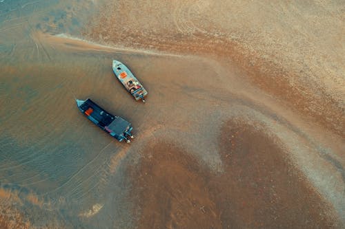 Bird's-eye View of Two Boats on Water Near Shore