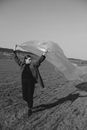 Grayscale Photo of a Woman Holding a Plastic