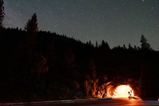 A stunning starry night sky above a lit tunnel in Yosemite National Park, CA.
