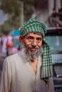 Man in Green and White Plaid Scarf and White Button Up Shirt